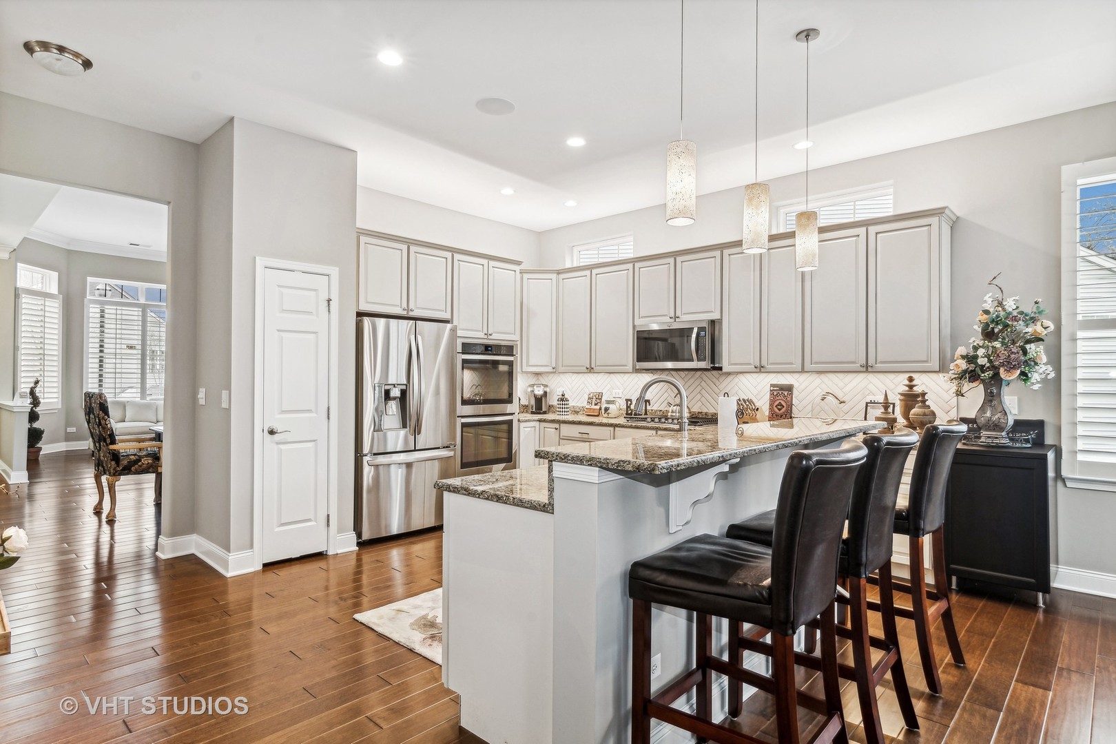 3870 Eagle Ridge Drive Elgin, IL 60124 - Photo 10 of 20 a kitchen with a table chairs refrigerator and microwave