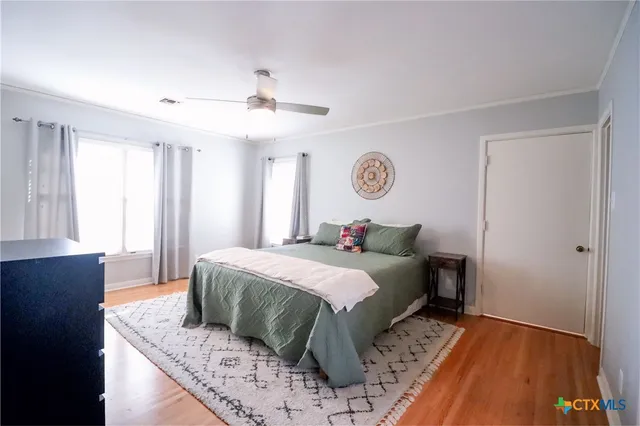 a bedroom with a large bed and a window