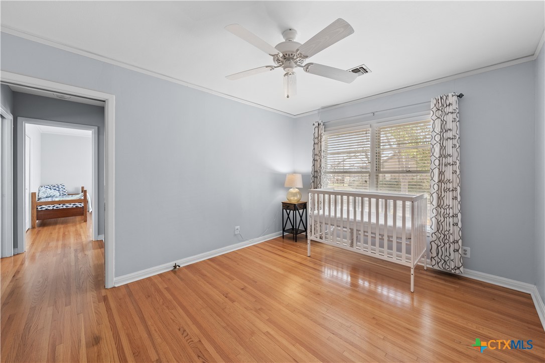 1902 North 7th Street Temple, TX 76501 - Photo 17 of 33 a view of a livingroom with wooden floor and a ceiling fan