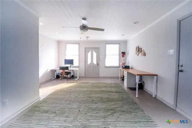 a view of a livingroom with furniture and a window