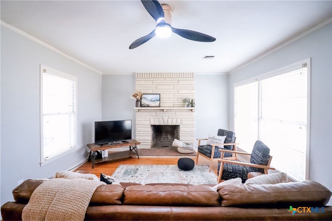 1902 North 7th Street Temple, TX 76501 - Photo 3 of 33 a living room with furniture a fireplace and a flat screen tv