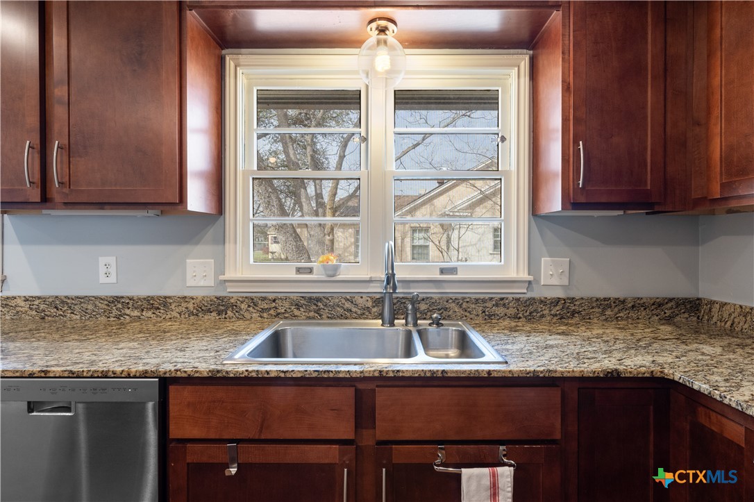 1902 North 7th Street Temple, TX 76501 - Photo 10 of 33 a kitchen with granite countertop a sink and a window