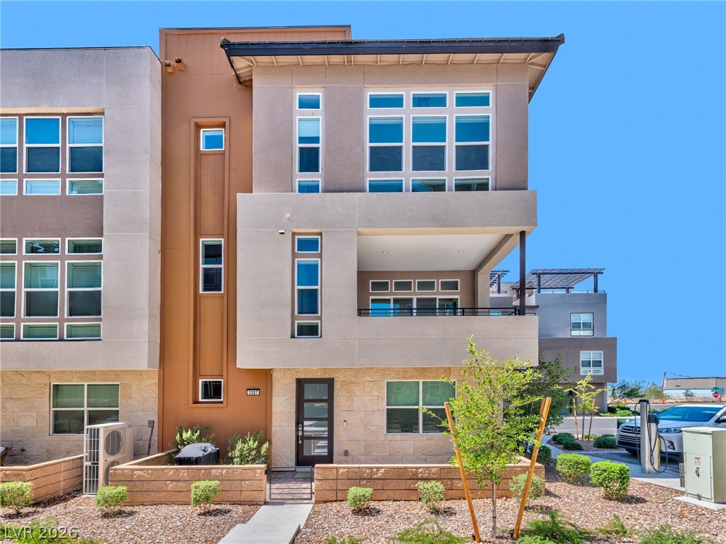 3327 Esker Rdg Avenue Henderson, NV 89044 - Photo 1 of 24 Modern townhouse with multi-level design and a welcoming stone-lined entryway.