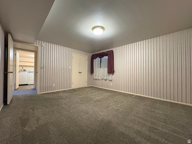 595 Meadowlark Road Orem, UT 84097 - Photo 57 of 87 Carpeted room featuring a ceiling-mounted light fixture, a window with curtains and blinds, and dual-door built-in storage