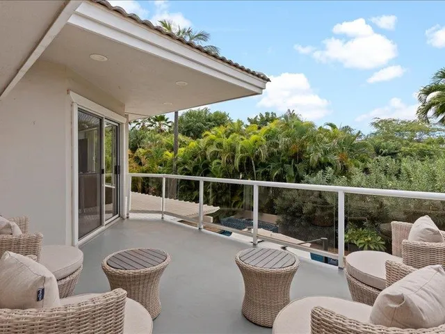 a view of a patio with couches chairs and potted plants