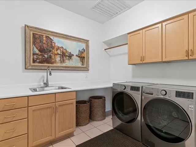 a utility room with sink dryer and washer