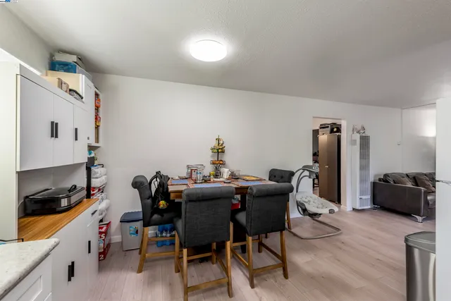a dining room with furniture and wooden floor
