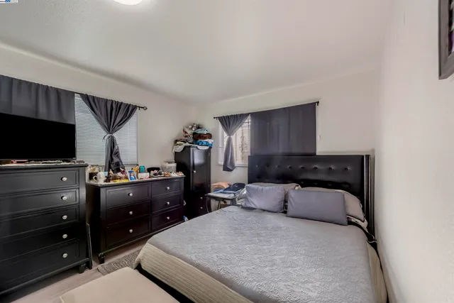 a bedroom with a bed and flat screen tv