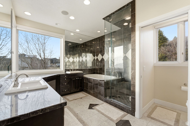 1878 East Ridge Point Drive Bountiful, UT 84010 - Photo 24 of 92 Full bathroom featuring a garden tub, double vanity, a shower stall, recessed lighting, and inlaid floor details