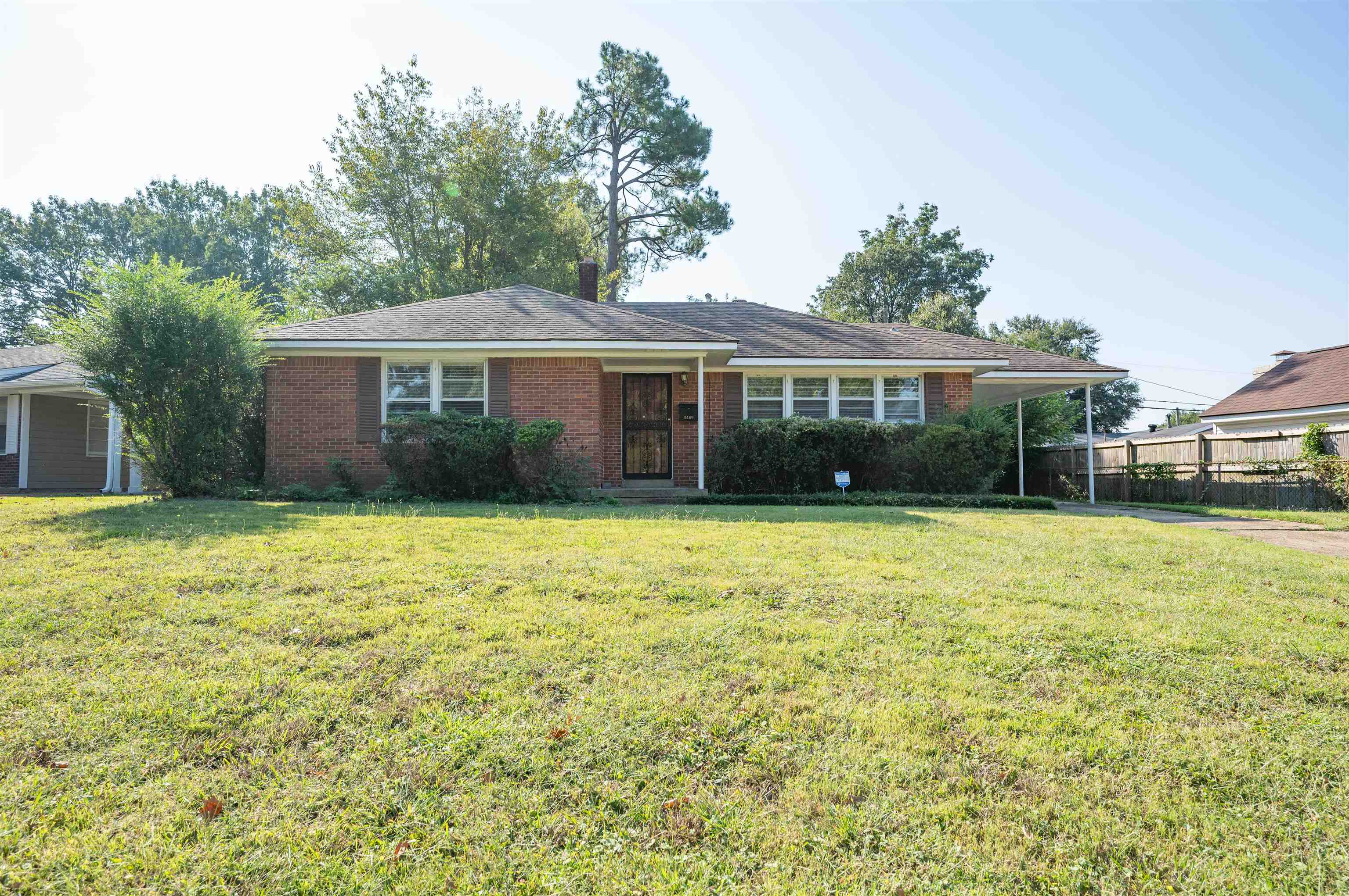 5189 Sea Isle Road Memphis, TN 38117 - Photo 1 of 16 Ranch-style house featuring a front yard and a carport
