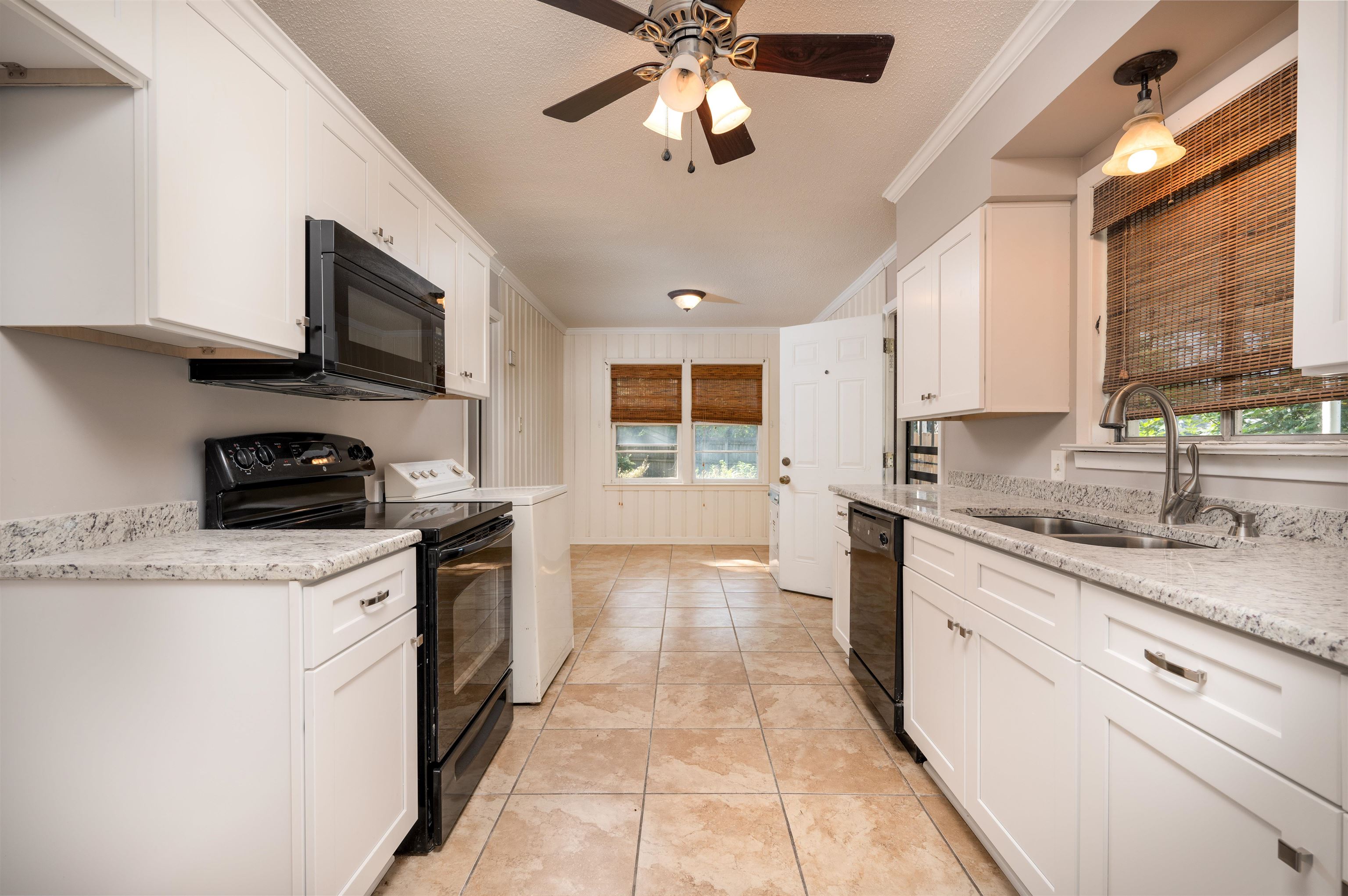 5189 Sea Isle Road Memphis, TN 38117 - Photo 5 of 16 Kitchen with sink, crown molding, a textured ceiling, white cabinets, and black appliances