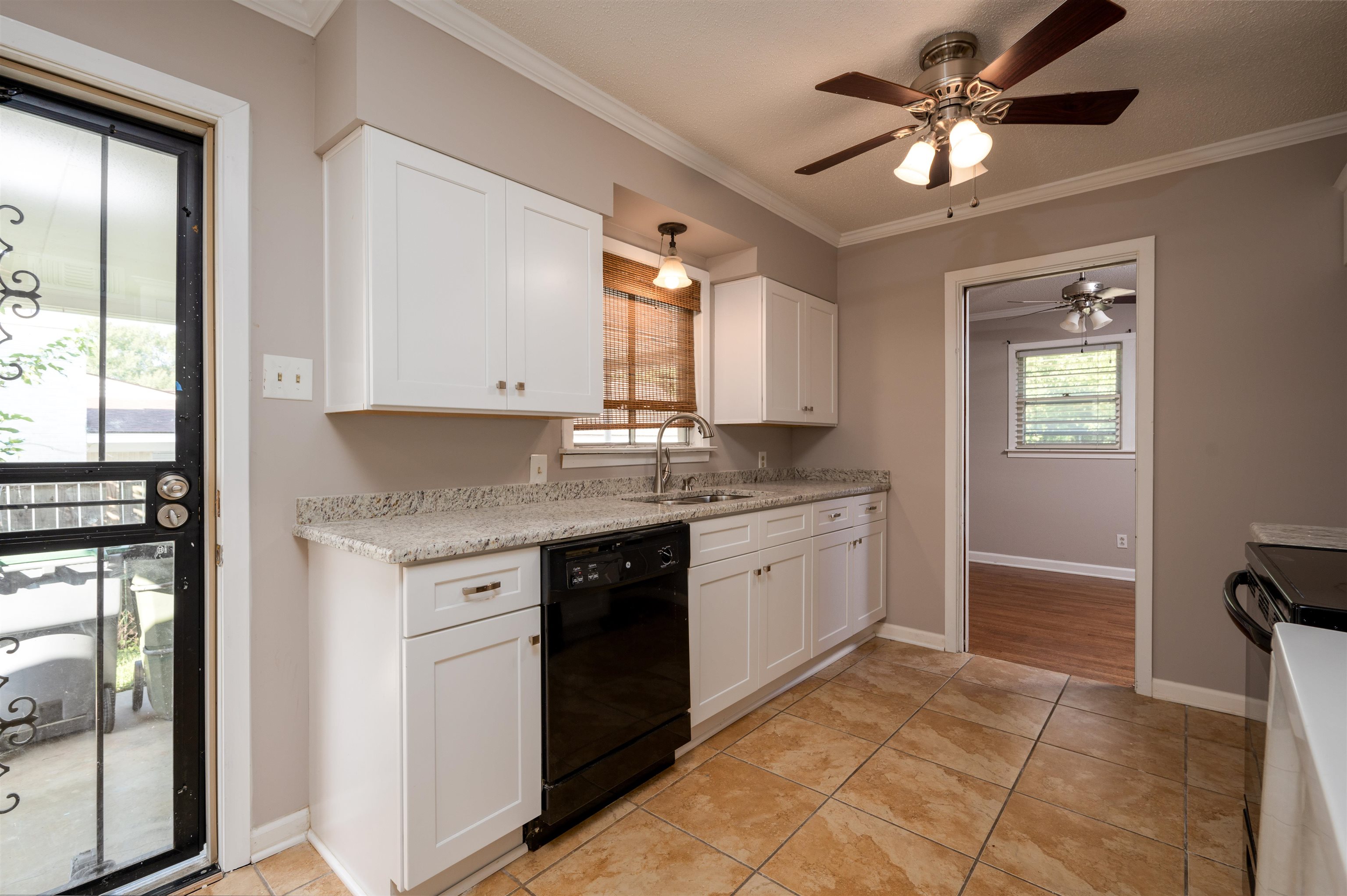 5189 Sea Isle Road Memphis, TN 38117 - Photo 6 of 16 Kitchen with black dishwasher, white cabinetry, a healthy amount of sunlight, and sink