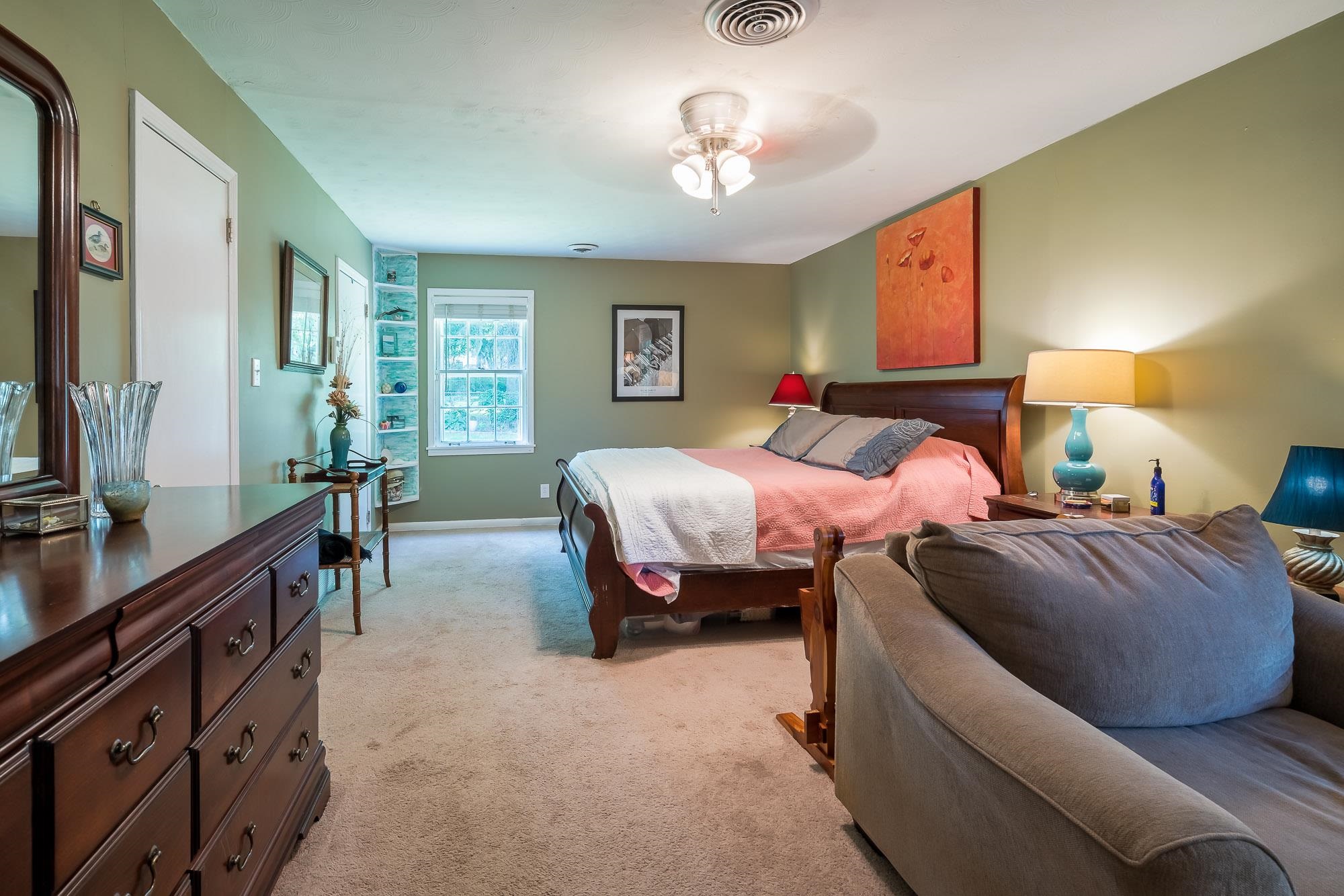4937 Dee Road Memphis, TN 38117 - Photo 12 of 24 a spacious bedroom with a bed and a chandelier