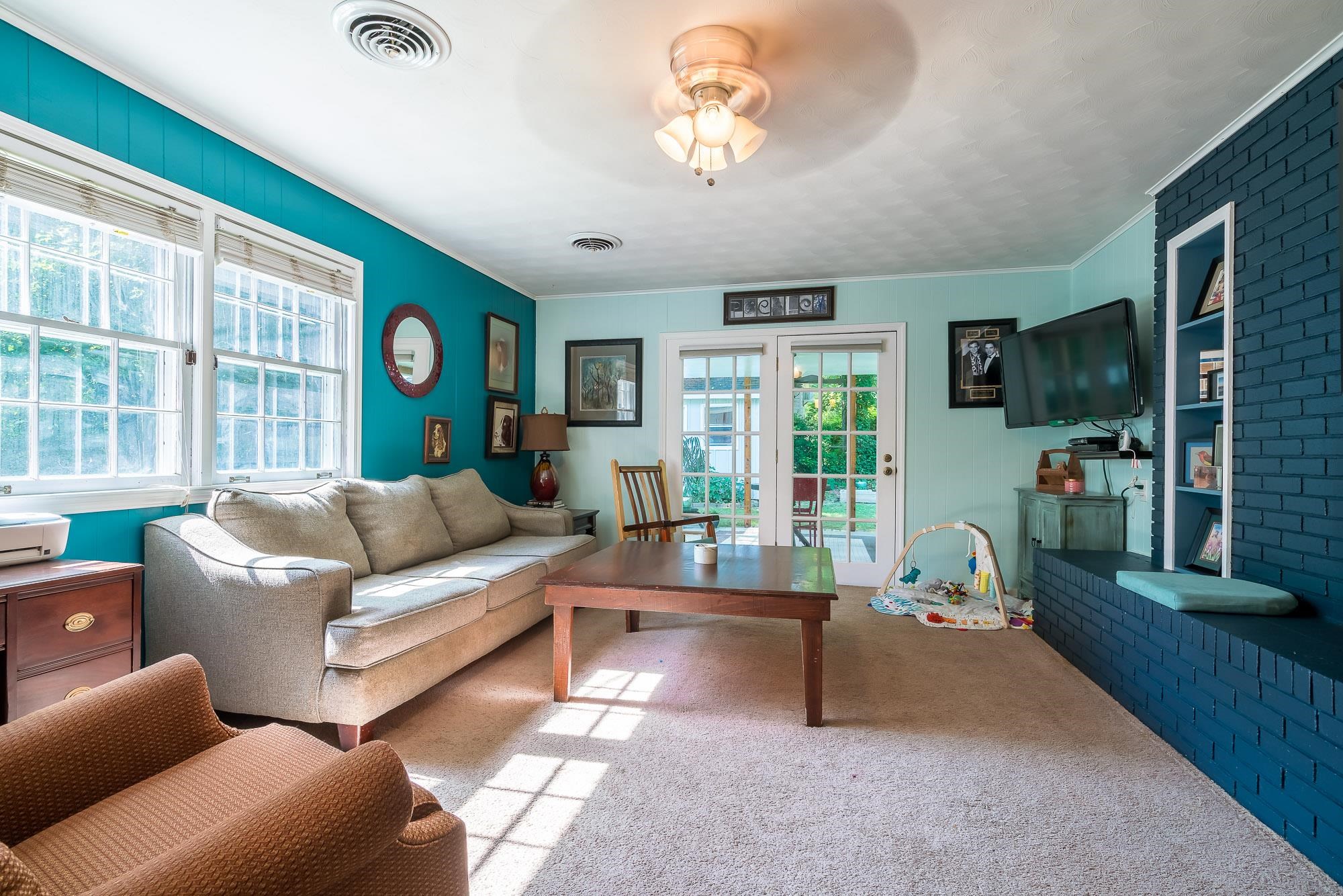 4937 Dee Road Memphis, TN 38117 - Photo 10 of 24 a living room with furniture a flat screen tv and a large window