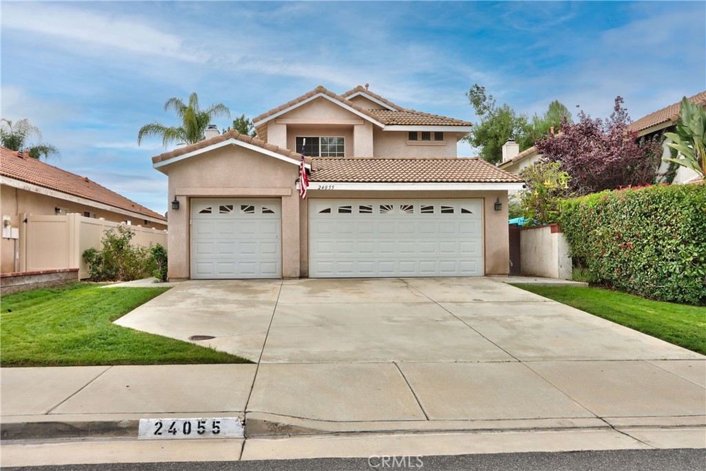 24055 Golden Pheasant Lane Murrieta, CA 92562 - Photo 1 of 38 a front view of a house with a yard and garage