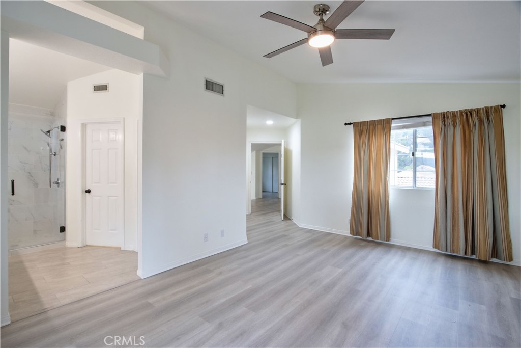 24055 Golden Pheasant Lane Murrieta, CA 92562 - Photo 21 of 38 a view of empty room with wooden floor and fan