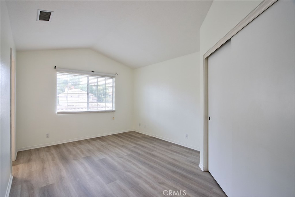 24055 Golden Pheasant Lane Murrieta, CA 92562 - Photo 28 of 38 an empty room with wooden floor and windows