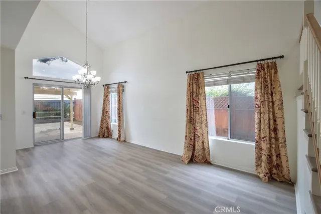 an empty room with wooden floor and a fireplace