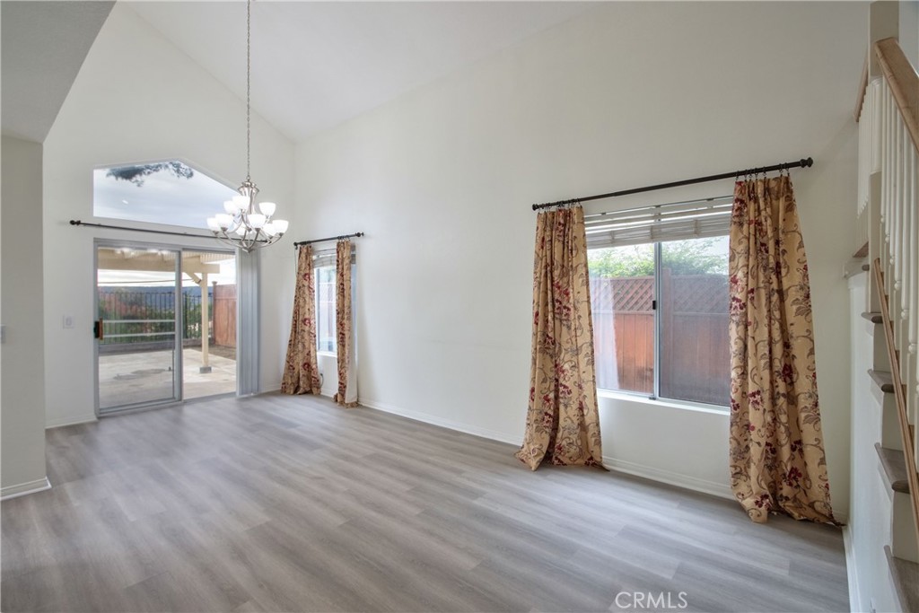 24055 Golden Pheasant Lane Murrieta, CA 92562 - Photo 3 of 38 an empty room with wooden floor and a fireplace