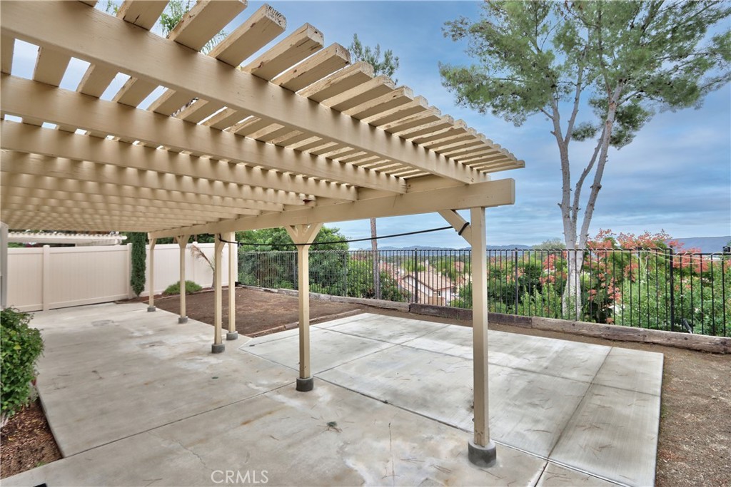 24055 Golden Pheasant Lane Murrieta, CA 92562 - Photo 34 of 38 a view of a patio with table and chairs and potted plants