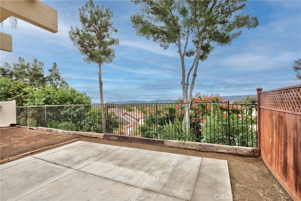 24055 Golden Pheasant Lane Murrieta, CA 92562 - Photo 36 of 38 a view of a garden with a tree in front of it