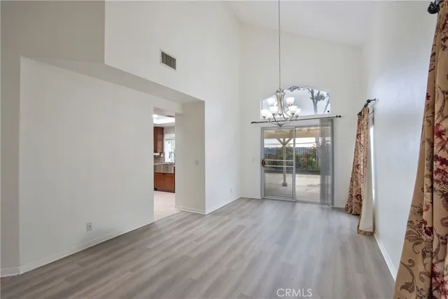 a view of a room with wooden floor