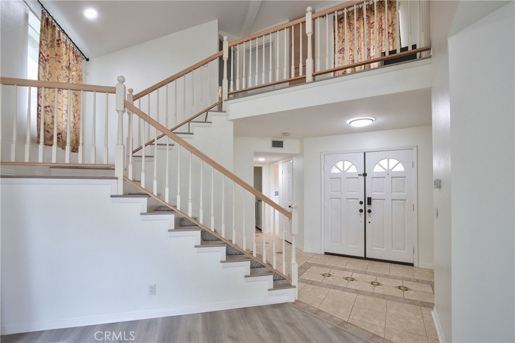24055 Golden Pheasant Lane Murrieta, CA 92562 - Photo 6 of 38 a view of staircase with white walls and a window