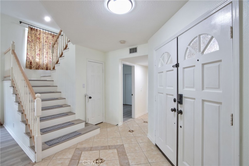 24055 Golden Pheasant Lane Murrieta, CA 92562 - Photo 7 of 38 a view of a hallway with a door and stairs