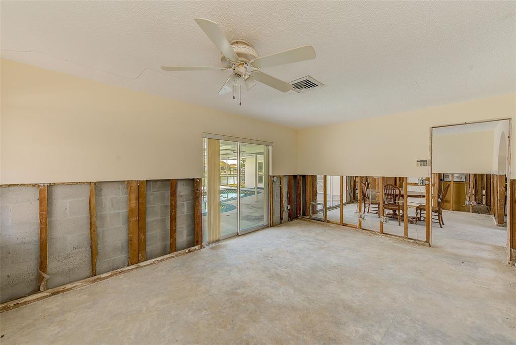 767 Island Way Clearwater, FL 33767 - Photo 32 of 74 an empty room with chandelier fan and windows
