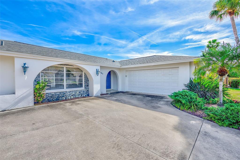 767 Island Way Clearwater, FL 33767 - Photo 4 of 74 a view of a house with garage and plants