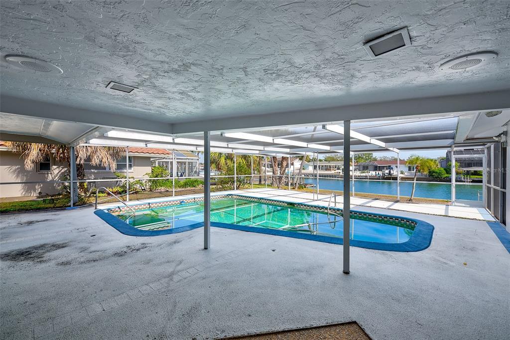 767 Island Way Clearwater, FL 33767 - Photo 42 of 74 a view of an empty room with wooden floor and iron stairs