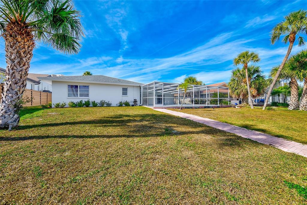 767 Island Way Clearwater, FL 33767 - Photo 52 of 74 a swimming pool with trees in front of it