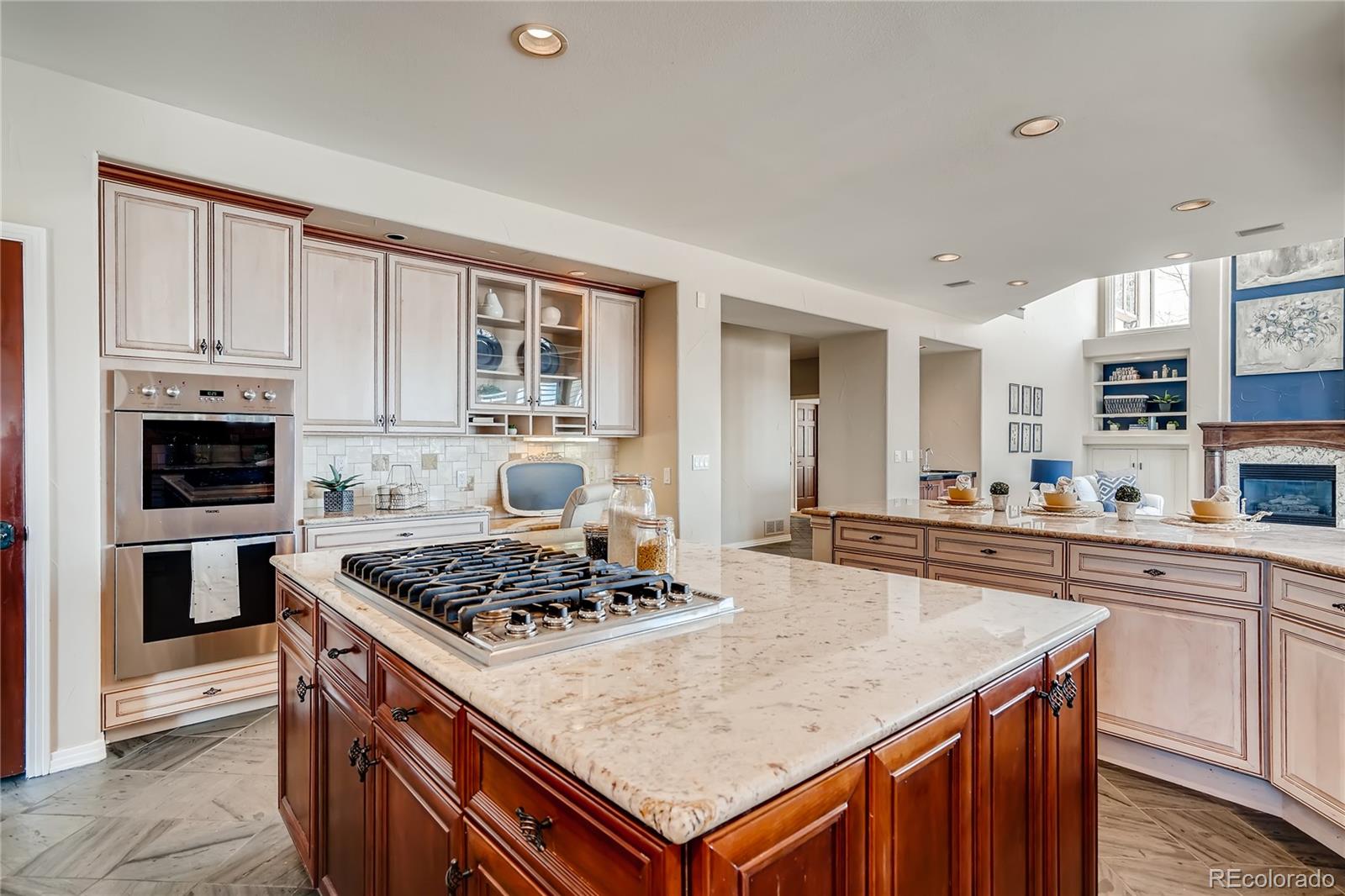 8618 Colonial Drive Lone Tree, CO 80124 - Photo 12 of 39 a kitchen with stainless steel appliances granite countertop a stove top oven a sink dishwasher and a refrigerator with wooden floor