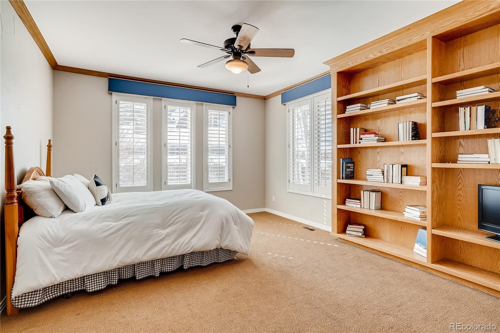 8618 Colonial Drive Lone Tree, CO 80124 - Photo 16 of 39 a spacious bedroom with a bed a dresser and a large window