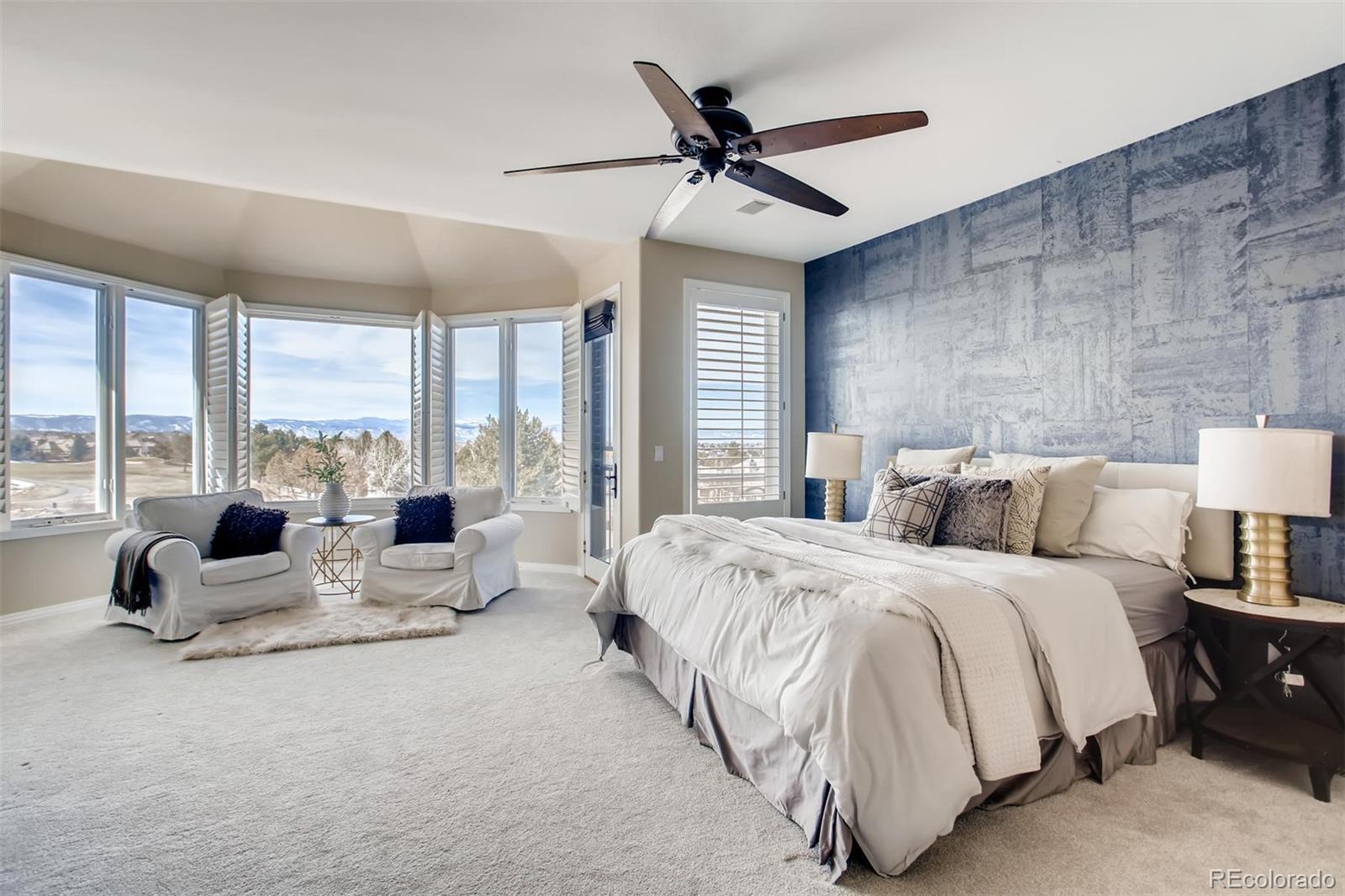 8618 Colonial Drive Lone Tree, CO 80124 - Photo 18 of 39 a spacious bedroom with a bed and large glass window