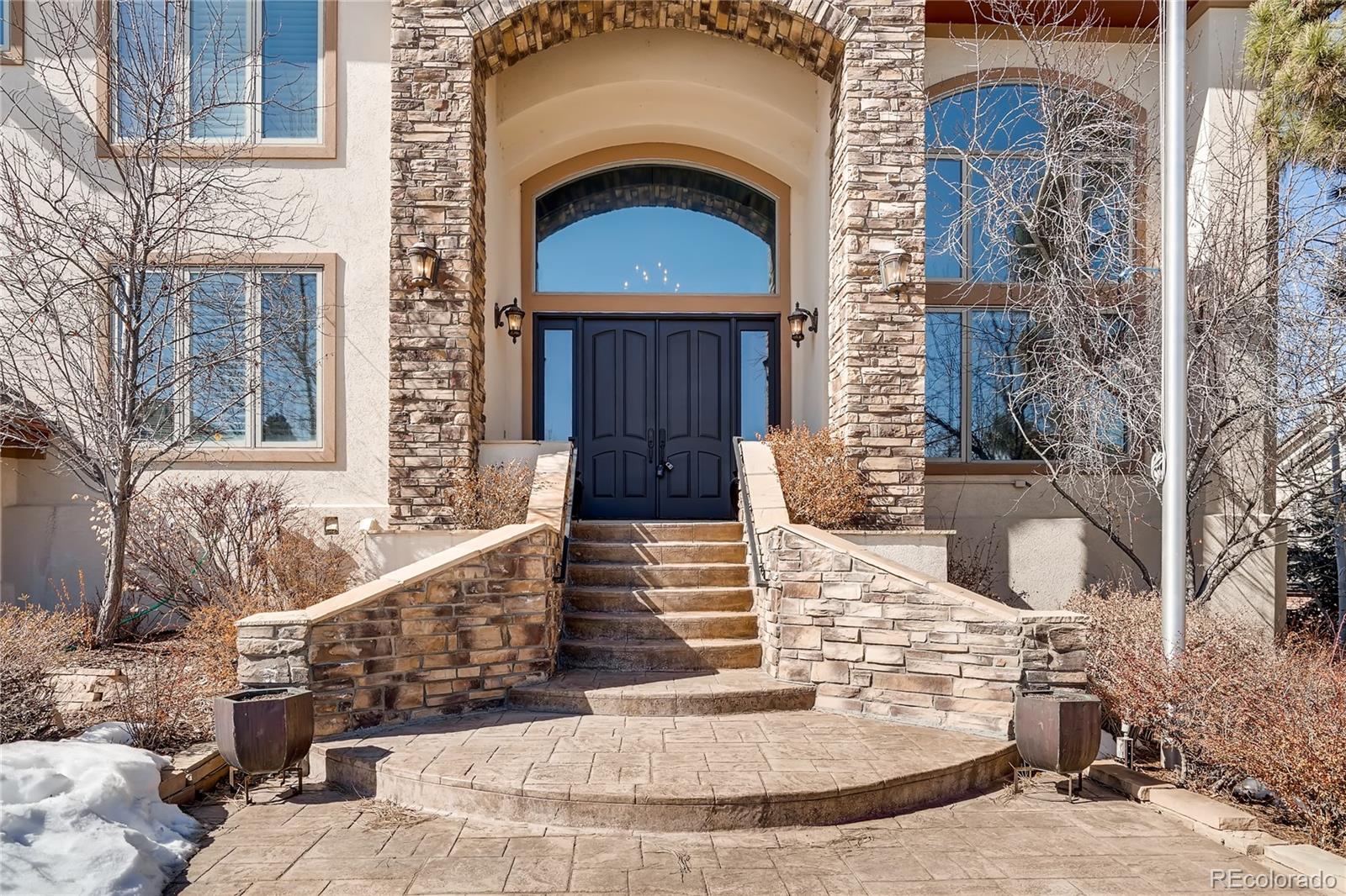 8618 Colonial Drive Lone Tree, CO 80124 - Photo 2 of 39 a view of a brick house with large windows