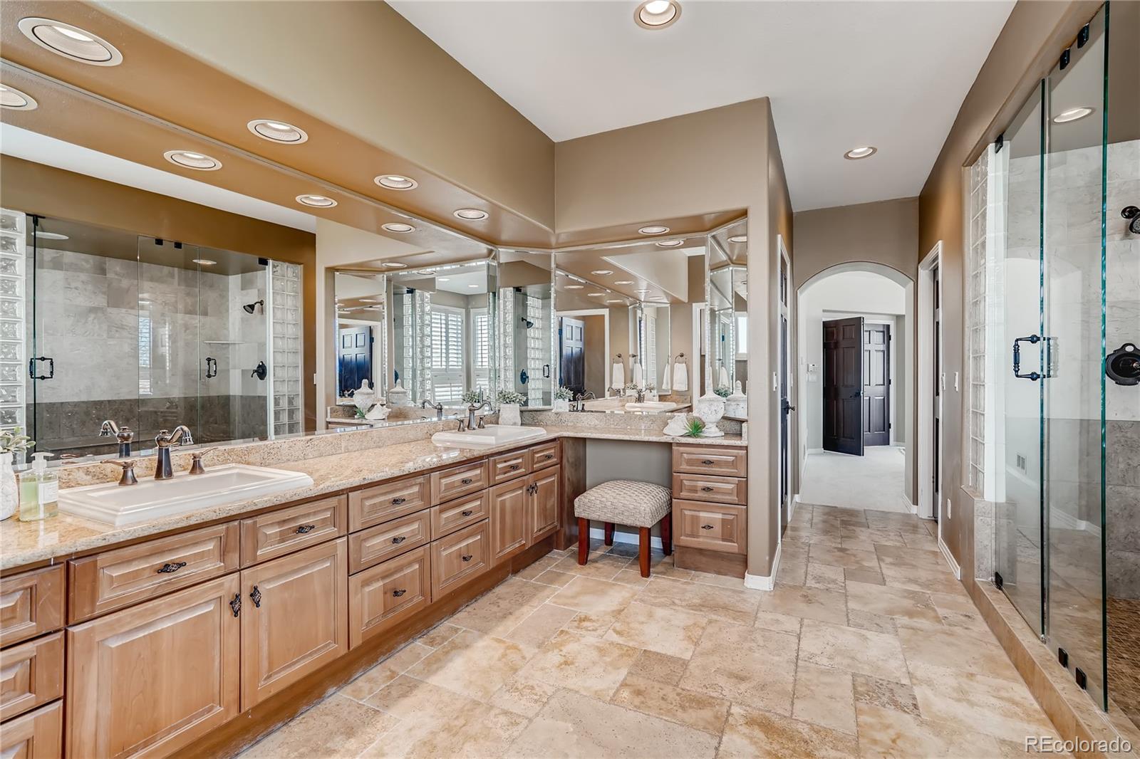 8618 Colonial Drive Lone Tree, CO 80124 - Photo 21 of 39 a spacious bathroom with a granite countertop sink mirror and a