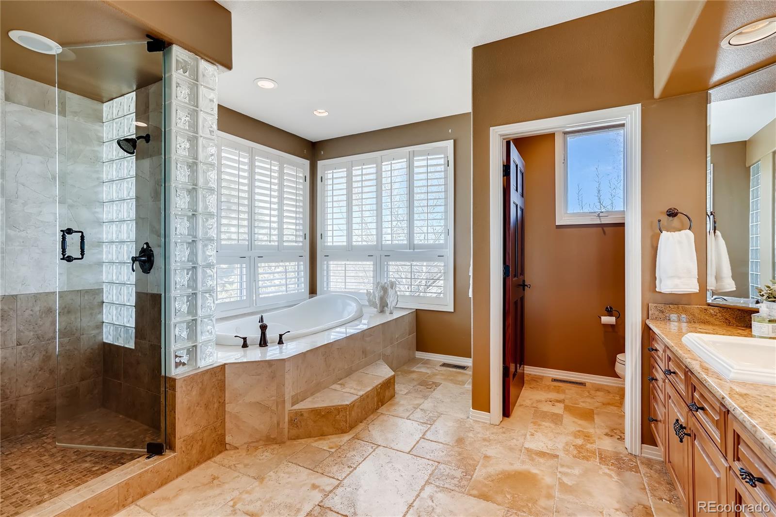 8618 Colonial Drive Lone Tree, CO 80124 - Photo 22 of 39 a spacious bathroom with a tub sink shower and mirror