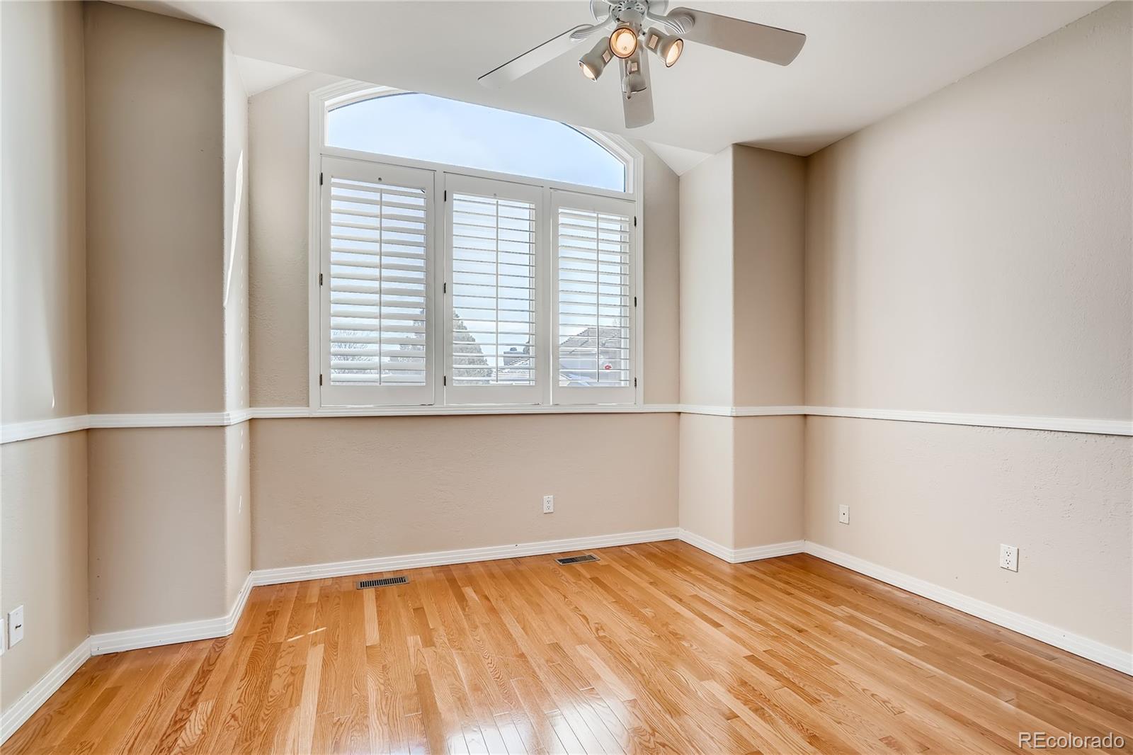 8618 Colonial Drive Lone Tree, CO 80124 - Photo 25 of 39 wooden floor in an empty room with a window