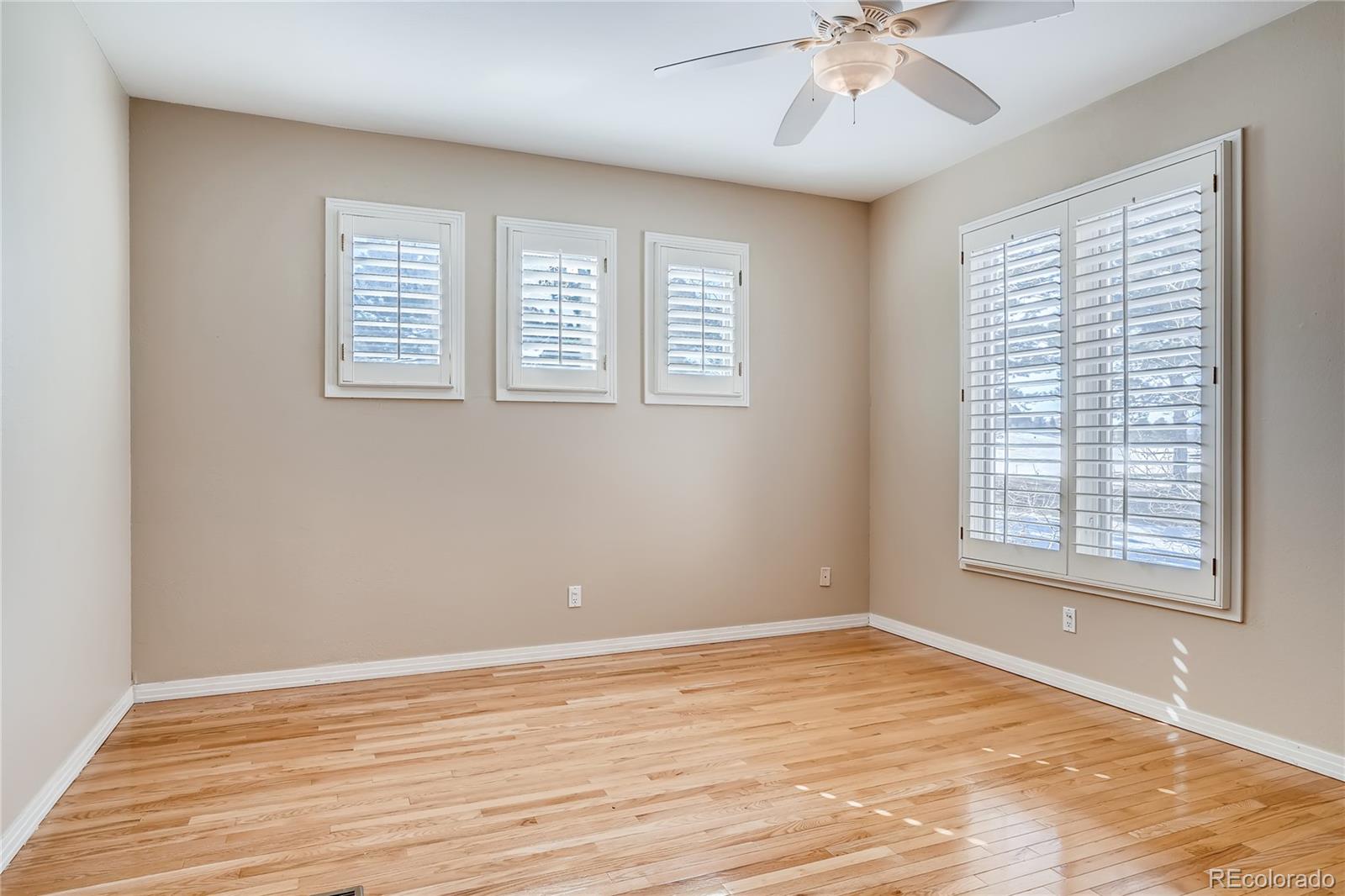 8618 Colonial Drive Lone Tree, CO 80124 - Photo 26 of 39 a view of an empty room with wooden floor and a window