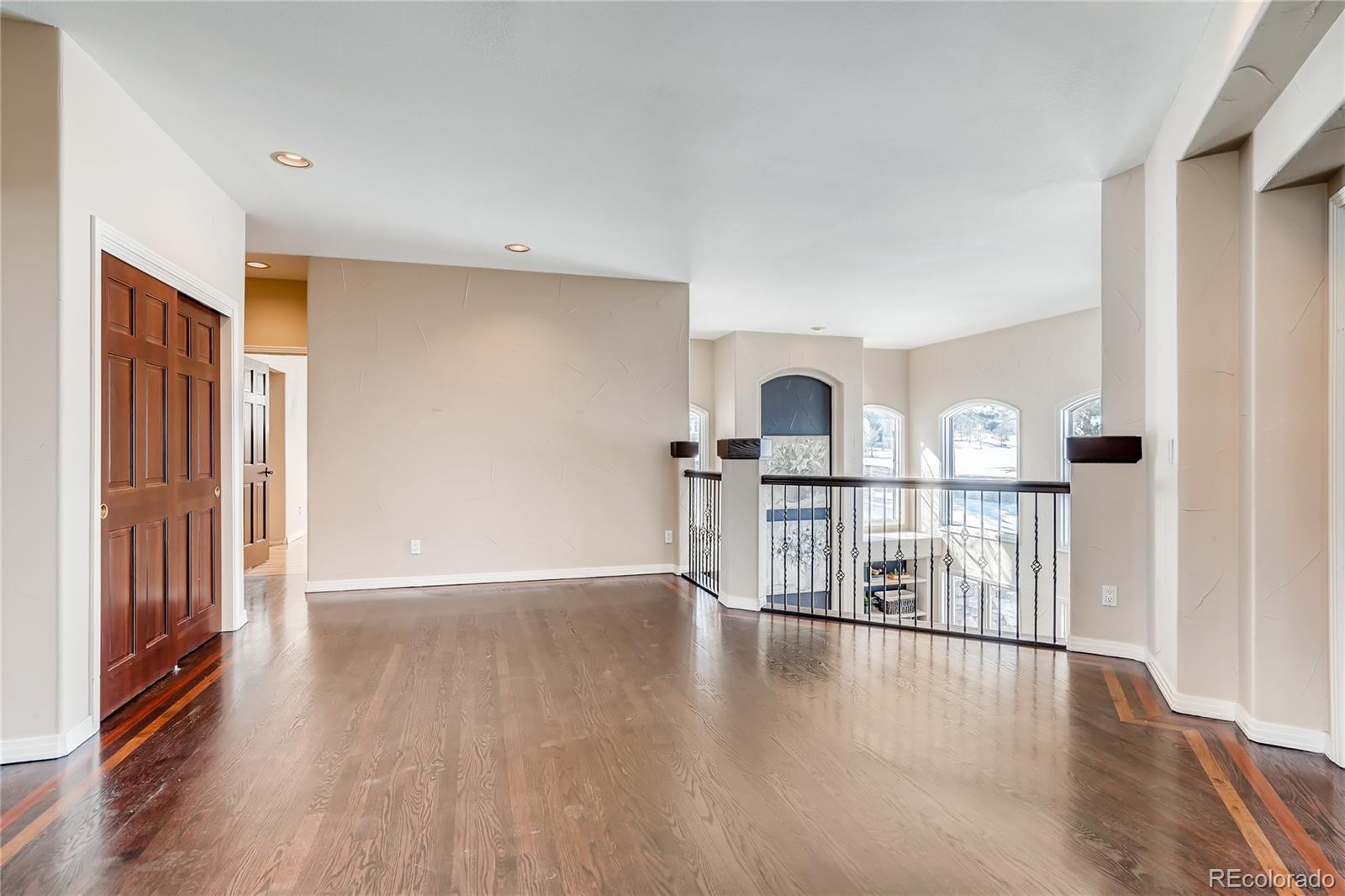 8618 Colonial Drive Lone Tree, CO 80124 - Photo 27 of 39 an empty room with wooden floor and windows