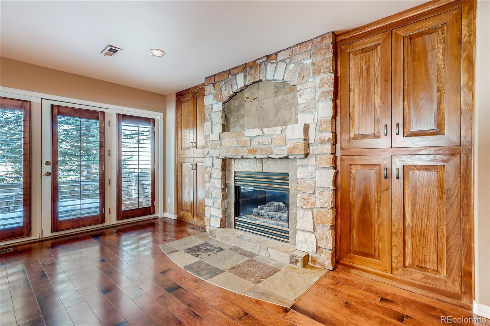 8618 Colonial Drive Lone Tree, CO 80124 - Photo 31 of 39 a living room with a fireplace furniture and a floor to ceiling window