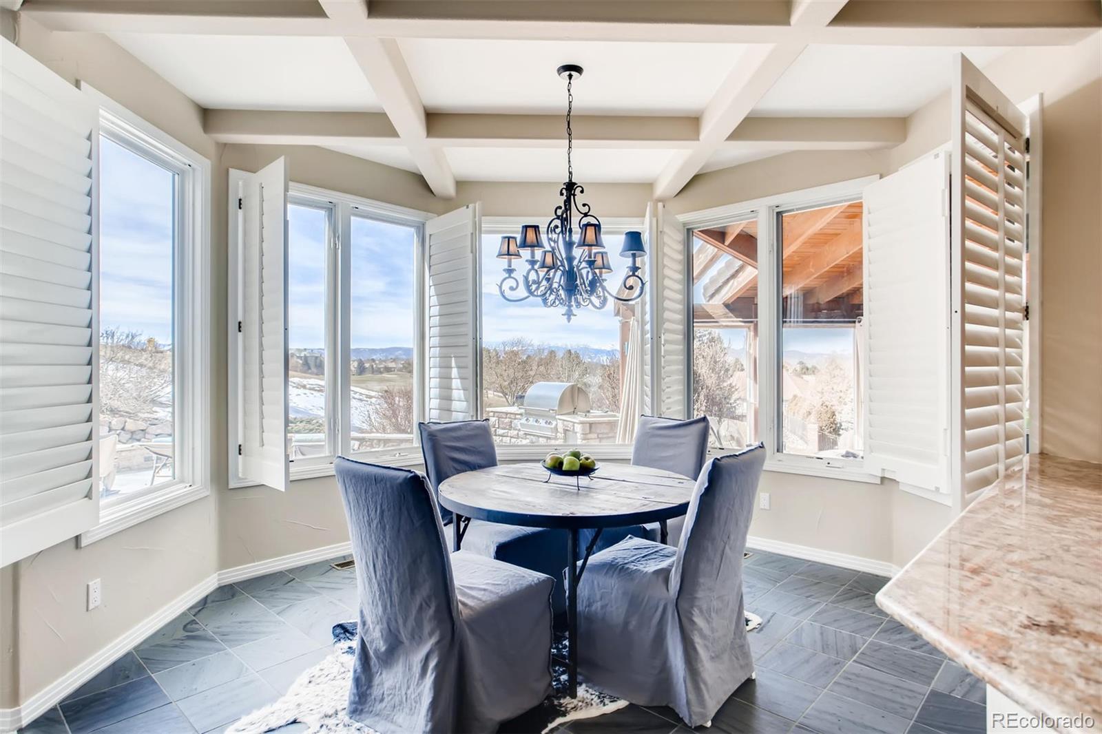 8618 Colonial Drive Lone Tree, CO 80124 - Photo 9 of 39 a view of a dining room with furniture window and wooden floor