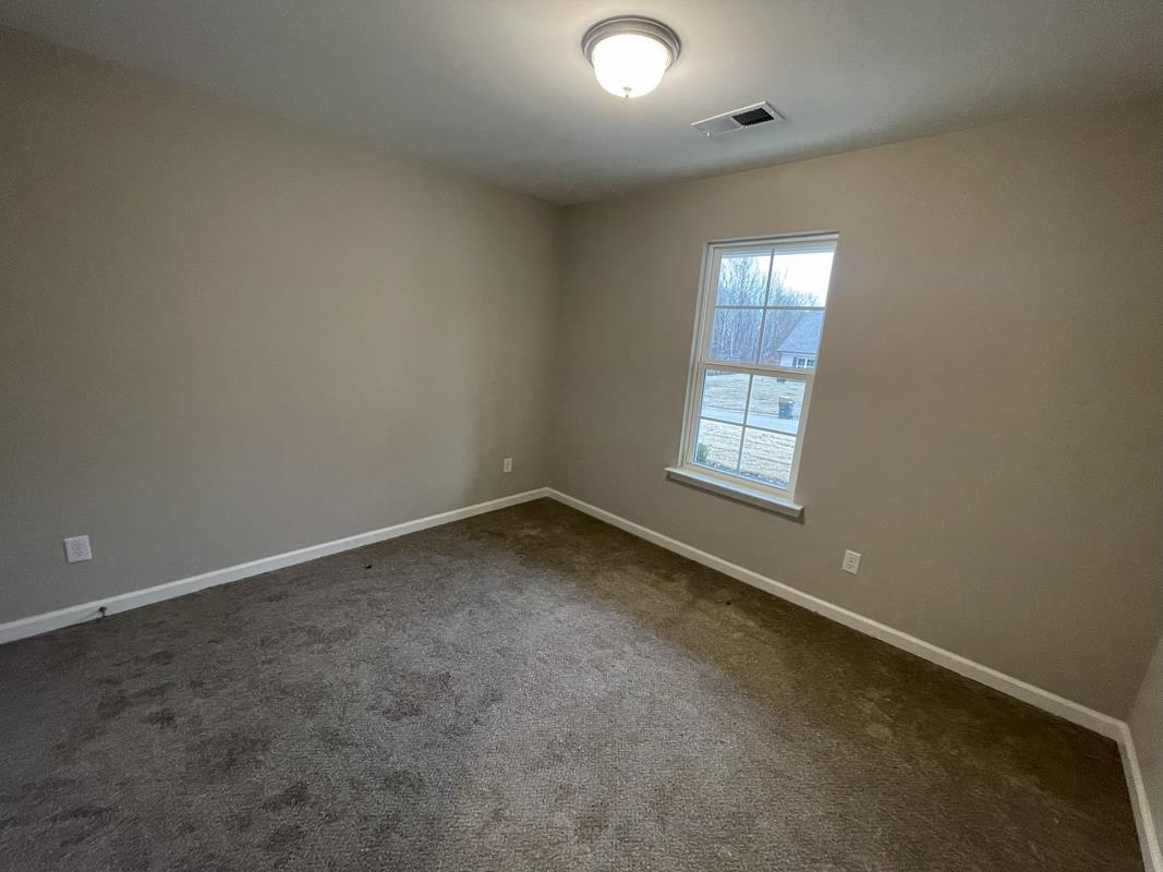 102 Stone Brook Cove Ripley, TN 38063 - Photo 13 of 19 an empty room with a window