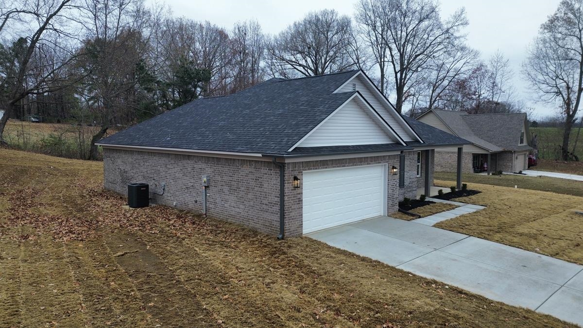 102 Stone Brook Cove Ripley, TN 38063 - Photo 16 of 19 a front view of a house with a yard and garage