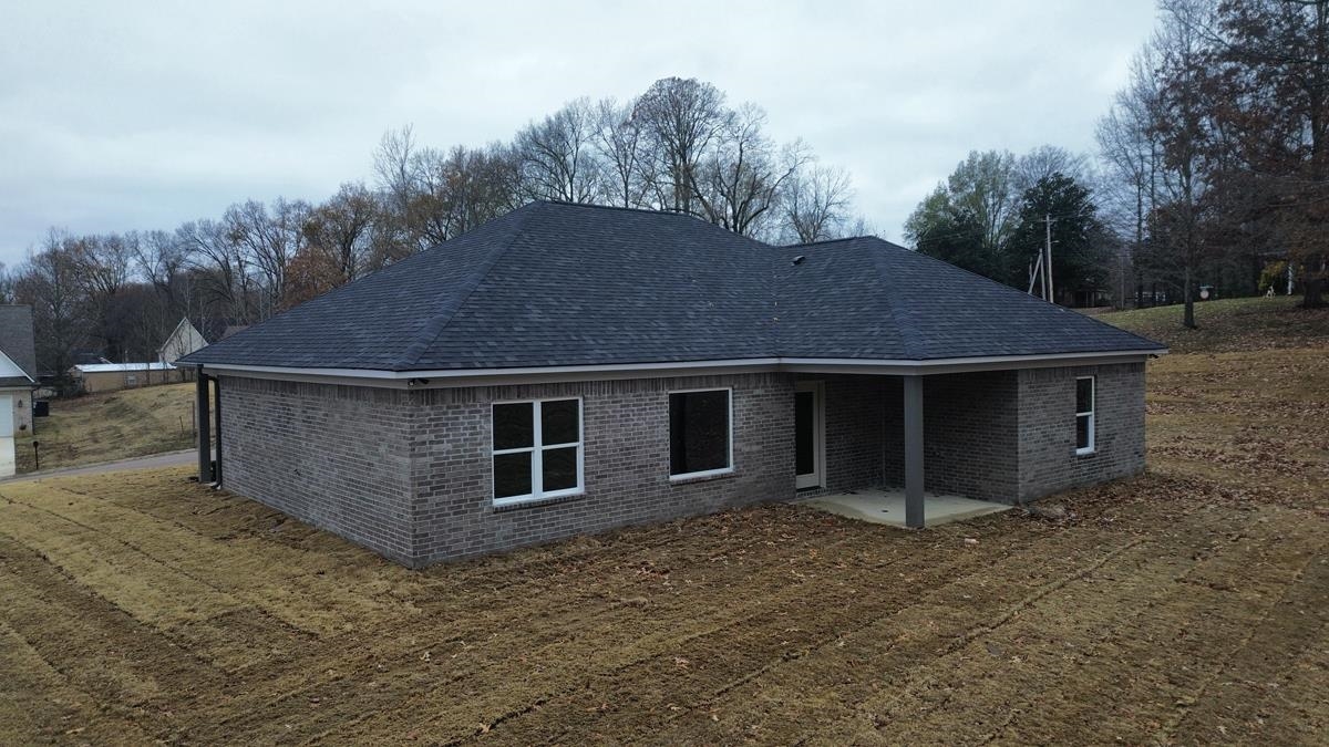 102 Stone Brook Cove Ripley, TN 38063 - Photo 17 of 19 a backyard of a house with lots of green space and outdoor seating