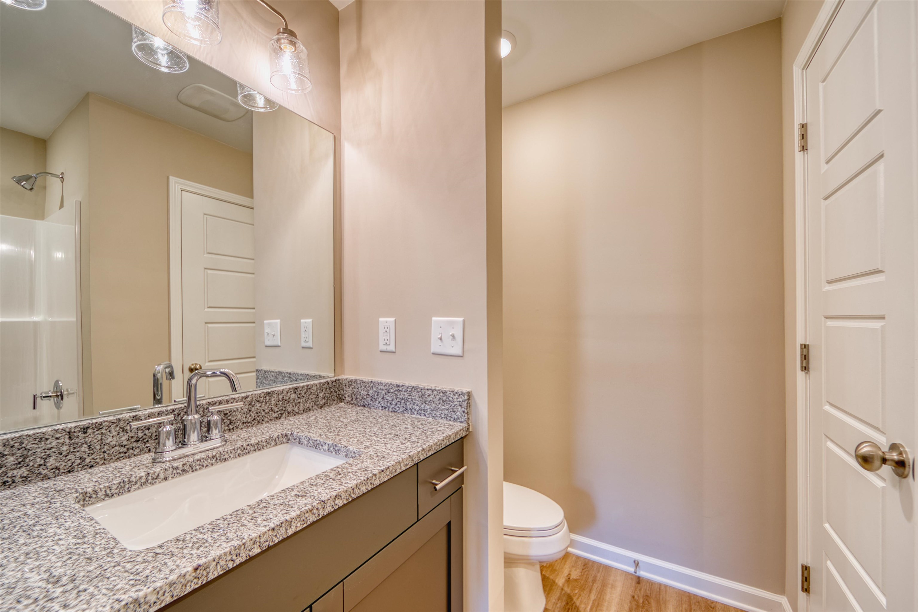 102 Stone Brook Cove Ripley, TN 38063 - Photo 25 of 32 a bathroom with a granite countertop sink toilet and shower