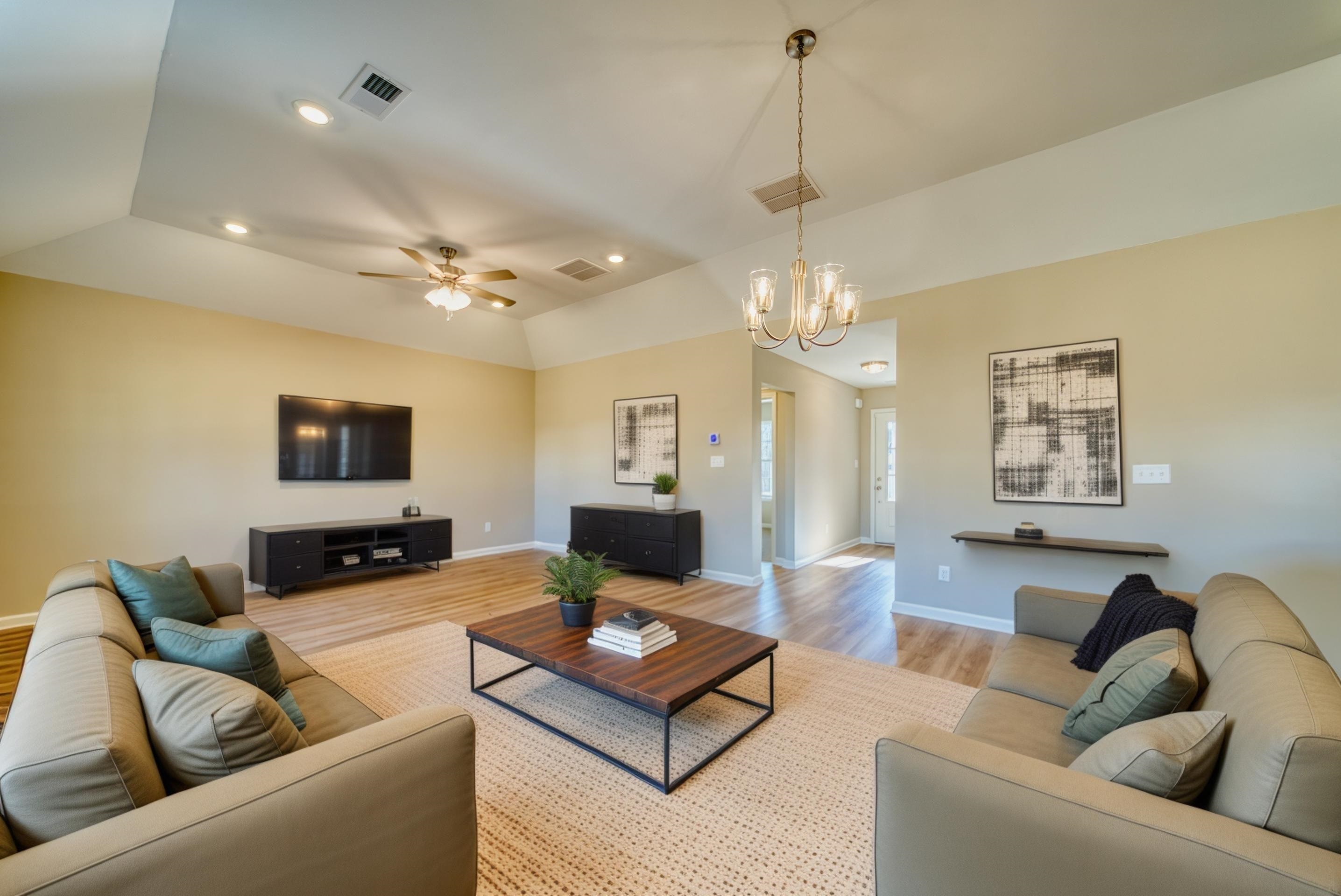 102 Stone Brook Cove Ripley, TN 38063 - Photo 3 of 32 a living room with furniture a chandelier and a couch