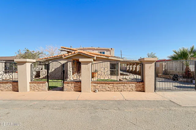 a view of a house with wooden fence