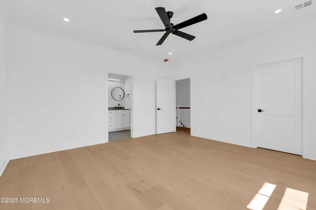 an empty room with closet and windows